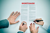man and woman signing a mortgage loan contract