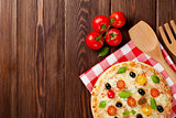 Italian pizza with cheese, tomatoes, olives and basil