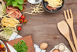 Pasta cooking ingredients and utensils on wooden table