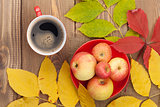 Autumn leaves, apple fruits and coffee cup