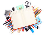 Blank notepad over school and office supplies on office table