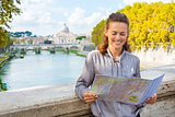 Elegant woman looking at map of Rome by Tiber River