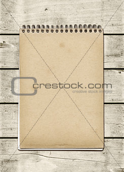 Closed spiral Note book on a white wood table