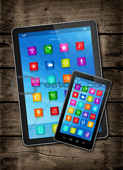 Smartphone and digital tablet PC with desktop icons on a dark wo