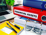 Financial Assets on Red Ring Binder. Blurred, Toned Image.