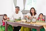 Indian family dining in kitchen