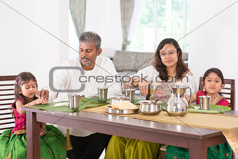 Indian family dining in kitchen