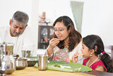 Indian family eating banana leaf rice