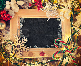 Christmas background with board in wooden frame and garland