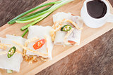 Fresh spring rolls on wooden table