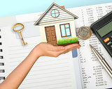 Humans hand holding house with key and calculator