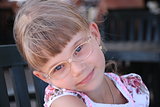 Smiling little blond girl with glasses