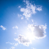Blue sky with sun and clouds