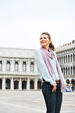 Smiling woman looking over shoulder on St. Mark's Square, Venice