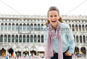 Laughing woman tourist leaning towards camera in St. Mark's