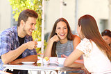 Friends talking in a coffee shop terrace