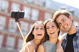 Group of tourist friends taking selfie with smart phone