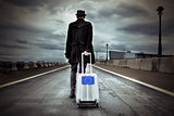 young man with a rolling suitcase with an European flag