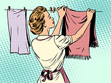 woman hangs clothes after washing housewife housework comfort