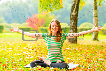 cheerful slim girl does yoga and laughs