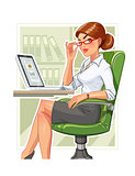 Business woman in armchair with laptop