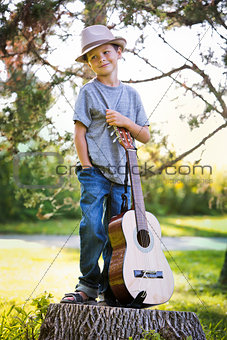 portrait of a little boy with guitar
