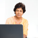 Indian mature woman using laptop computer