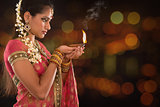 Indian girl hands holding diwali lights