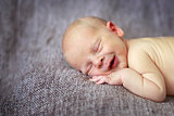 sleeper newborn baby on a gray background
