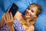 Girl In Bed Reading Love Phone Message From Boyfriend