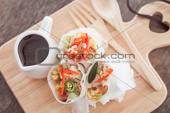 Fresh spring rolls on wooden table