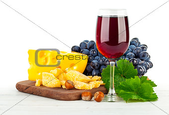 Glass red wine with grapes and cheese