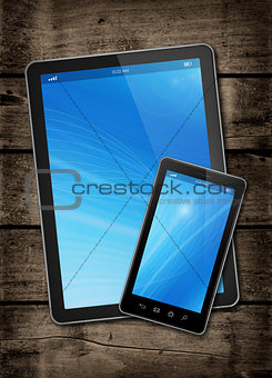 Smartphone and digital tablet PC on a dark wood table
