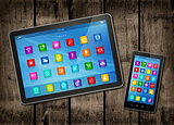 Smartphone and digital tablet PC with desktop icons on a dark wo