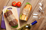 Two sandwiches and white wine