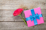 Purple gerbera flower and gift box
