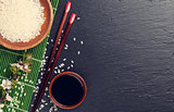 Japanese sushi chopsticks, soy sauce bowl, rice and sakura bloss