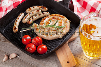 Grilled sausages and beer mug