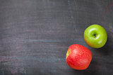 Green and red apples on blackboard or chalkboard background