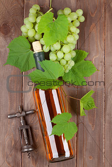 Bunch of grapes, white wine and corkscew
