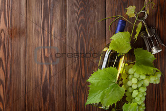 Bunch of grapes, white wine bottle and corkscrew