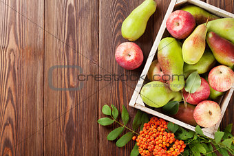 Pears and apples in wooden box