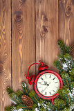 Christmas wooden background with clock, snow fir tree