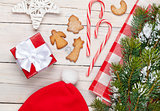 Christmas gift box, santa hat, gingerbread cookies and snow fir 