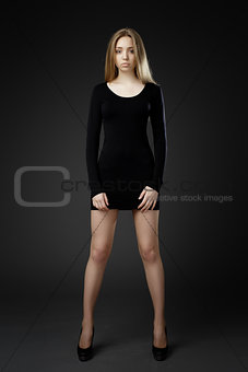 Full-length portrait young elegant woman in black dress.