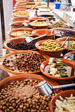 Different marinated olives and local food on spanish street mark