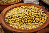 Different marinated olives and local food on spanish street mark