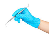 gloved hand holding a metal dental instruments plugger - trowel 