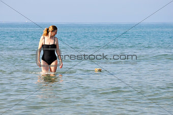 girl and dog in sea