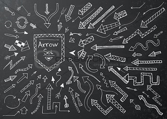 Hand drawn arrow icons set on black chalk board